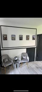 a living room with two chairs and a table at Edinburgh 2 bedroom ground floor apartment in Edinburgh