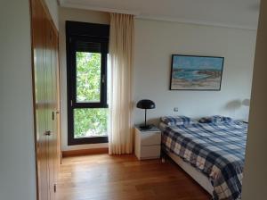 A bed or beds in a room at Bonita vivienda en San Sebastian de los Reyes