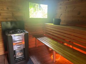 a room with a stove and a bench in a log cabin at Viol in Filipstad