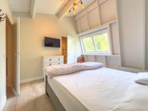Ένα ή περισσότερα κρεβάτια σε δωμάτιο στο Vakantieappartement Oostkapelle