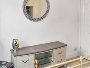 un espejo en la pared sobre un tocador en una habitación en Little Fishes, en Ryde