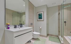 a bathroom with a sink and a toilet and a shower at 5 Star Elegant Apartments, Ellipse, Waterfall City, Midrand, Johannesburg in Midrand +67 photos