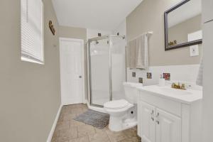 a bathroom with a shower and a toilet and a sink at Two Spaces in One Main House and Guest House 25 Min to PCB in Panama City