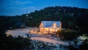 a house with a blue roof on a beach at Above All Luxury Lodge in New Braunfels