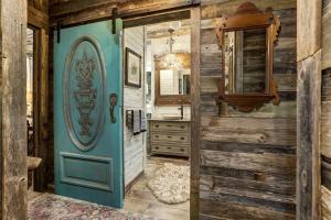 a bathroom with a blue door and a mirror at Above All Luxury Lodge in New Braunfels +38 photos