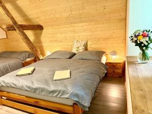 a bedroom with a bed with two towels on it at Na Mlejně in Krahulčí
