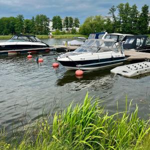 a group of boats are docked in the water at Apartament SOLMARINA in Iława