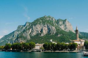 a mountain in front of a city and a body of water at Tra Monti e Lago in Lecco