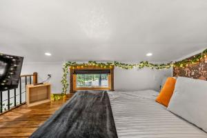 a bedroom with a large bed and a television at The Fern Hollow Retreat in Woodland Park