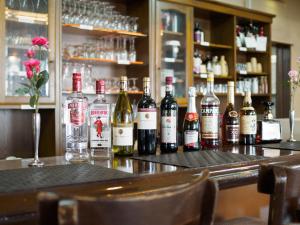 a group of bottles of wine sitting on a bar at Business Green Hotel Hino in Hino