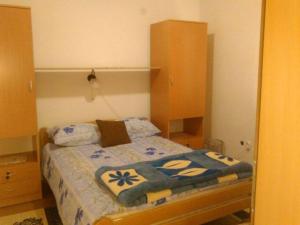 a bedroom with a bed with blue flowers on it at Vila Zlata in Gornja Trepča