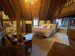 a living room with a bed and a couch at La Roulière en Aubrac in Montpeyroux +54 photos