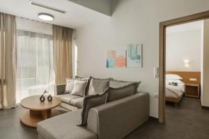 a living room with a couch and a table at Tortuga Luxury Villas Sivota in Syvota +87 photos