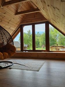 a room with a large window in a cabin at Siedlisko pod brzozami in Bielsk Podlaski +5 photos