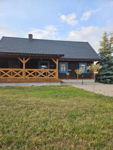 a large wooden house with a yard in front of it at Siedlisko pod brzozami in Bielsk Podlaski