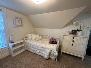 a bedroom with a bed and a table and a window at Charming Brick House in Little Chute