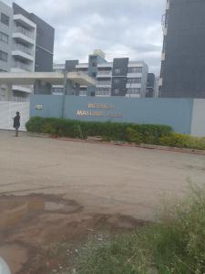 a woman standing in front of a large building at Hanover Studio Homes in Nairobi