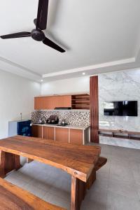 une cuisine avec une table en bois dans une pièce dans l'établissement Senggigi Cottages Lombok, à Senggigi