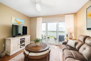 a living room with a couch and a tv at Waterfront Resort , World Class Marina & Slip in Beaufort