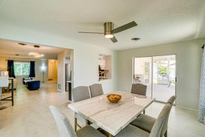 a dining room and living room with a table and chairs at Casa Mar Van Beautiful Property with Heated Pool and Spa minutes to beaches and golf in Rotonda West