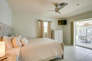 a bedroom with a bed and a dresser and a patio at Casa Mar Van Beautiful Property with Heated Pool and Spa minutes to beaches and golf in Rotonda West +17 photos