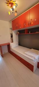 a bedroom with two beds and orange cabinets at Exclusiv new family in Năvodari