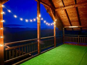a balcony with a view of the mountains at night at Eden in Piatra Fantanele