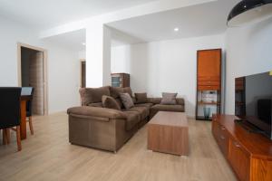 a living room with a couch and a table at LETS HOLIDAYS Wake Up by the Sea in Victoria apartment 2 in Tossa de Mar