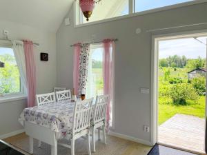a bedroom with a bed and a large window at Charming Garden Cottage in Levide in Hemse +14 photos