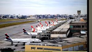 a row of airplanes parked at an airport at Hotel Nobrega - São Paulo - Aeroporto Congonhas in Sao Paulo