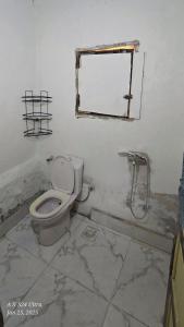 a dirty bathroom with a toilet and a mirror at Dahab house home in Dahab +6 photos