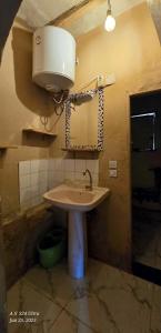 a bathroom with a sink and a light and a mirror at Dahab house home in Dahab