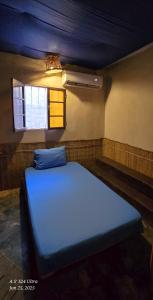 a blue bed in a room with a window at Dahab house home in Dahab