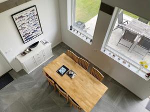 a dining room with a table and two windows at 4 star holiday home in Gotlands Tofta in Tofta