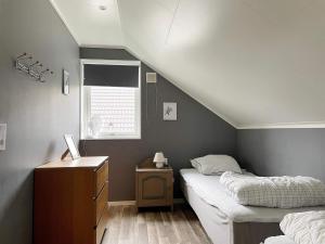 a bedroom with two beds and a dresser and a window at 4 star holiday home in Gotlands Tofta in Tofta