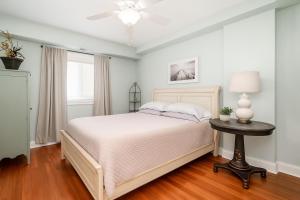 a bedroom with a bed and a table with a lamp at Waterfront Resort , World Class Marina & Slip in Beaufort +32 photos