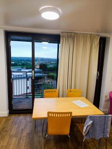 a dining room table with chairs and a large window at Perth Youth Hostel and Apartments in Perth +40 photos