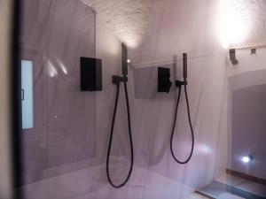 a bathroom with two shower systems on a wall at Lupariello Relais in Altamura