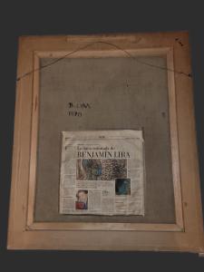a newspaper in a wooden frame with a newspaper at Hotel Boutique Premium Exclusivo in Paine