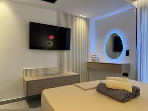 a bedroom with a tv hanging on the wall at VITHΟS SUITE Luxury Living in Virós +15 photos