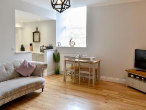 a living room with a table and a couch at Jubilee House in Alnwick