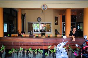 a woman standing in front of a bar with plants at Manee Cool Mueang in Chiang Mai +55 photos
