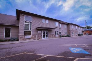 an empty parking lot in front of a house at Canby Inn and Suites in Canby