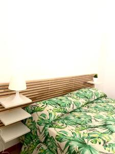 a bedroom with a bed with a green pineapple bedspread at Villa Marhù in Mattinata