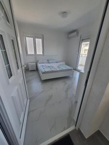 Una cama o camas en una habitación de Apartmani Ajla