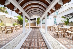 a patio with tables and chairs in a building at Hotel Boutique Zahara in Zahara de los Atunes