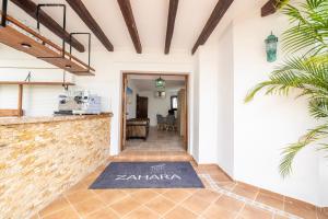 a hallway of a house with a rug on the floor at Hotel Boutique Zahara in Zahara de los Atunes +15 photos