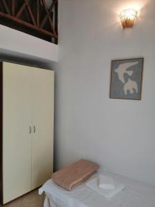 a white room with a bed and a cabinet at Noka Nikiti in Nikiti +41 photos