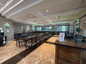 a restaurant with tables and chairs and a bar at Exclusive Doral Villa with Luxury Amenities in Miami