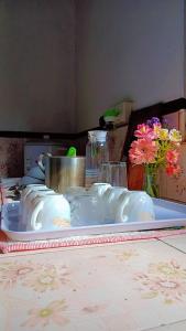 a white plate on a table with flowers on it at OSRA HOLIDAY In in Katunayaka